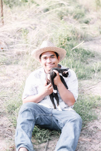 istock happy farmer playing with his cat 1151769059