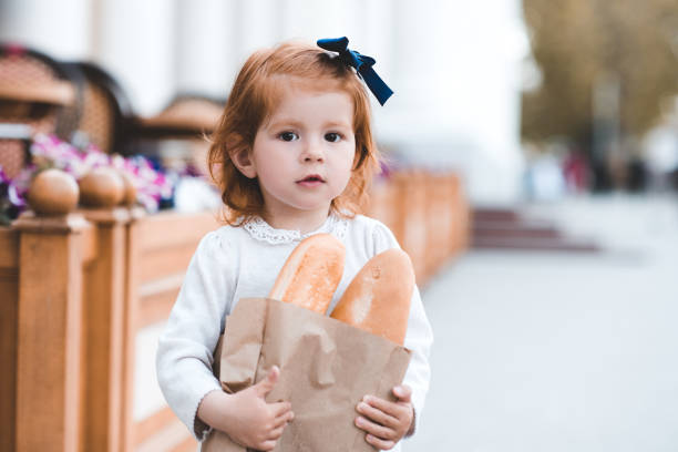 istock Girl with fresh bread 1151769997