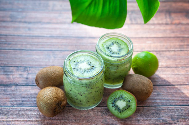 istock Kiwi smoothies in glass cups on a wooden table 1151772145