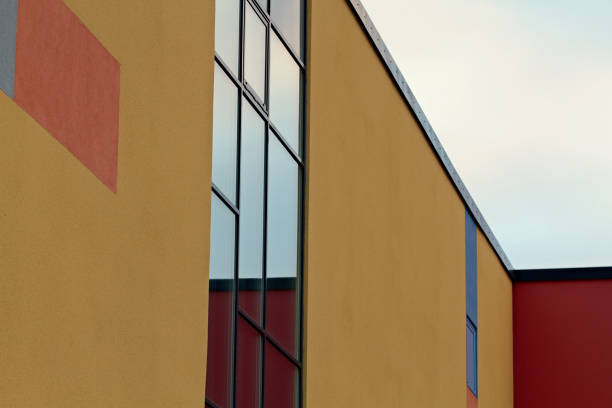 istock Yellow painted building with big windows 1151774336