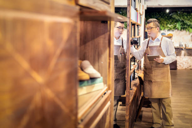 istock Sales clerk checking shoes in boutique 1151774810