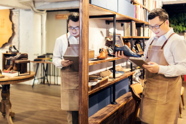 istock Sales clerk checking shoes in boutique 1151774811
