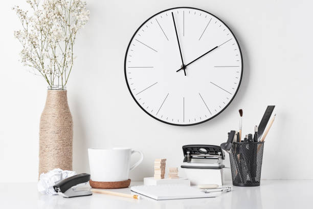 istock Office supplies and wall clock on white 1151775824