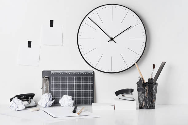 istock Office supplies and wall clock on white 1151775829