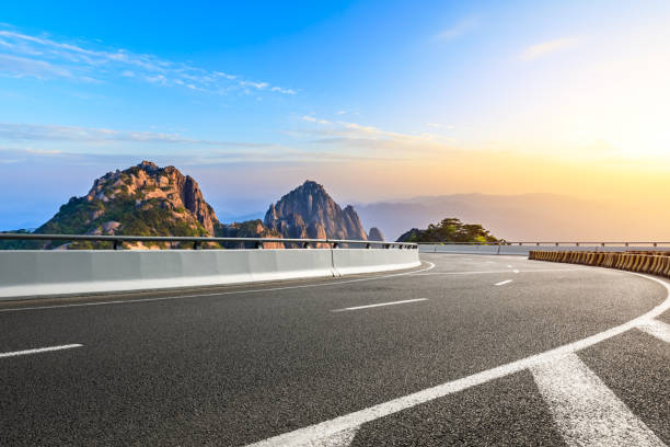 Asphalt highway road and beautiful huangshan mountains nature landscape Asphalt highway road and beautiful huangshan mountains nature landscape at sunrise huangshan mountains stock pictures, royalty-free photos & images