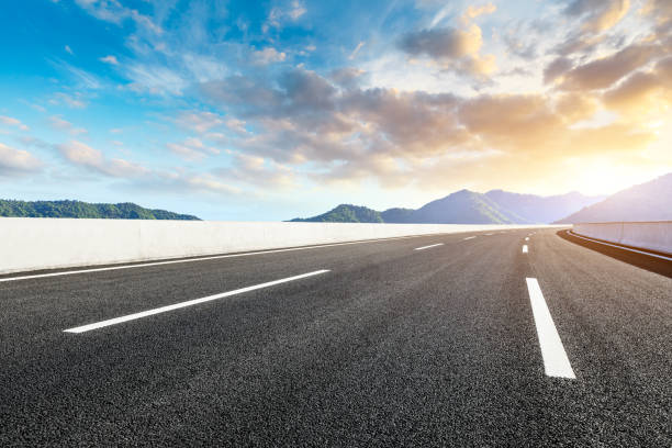istock Highway road and beautiful mountain with clouds landscape 1151776002