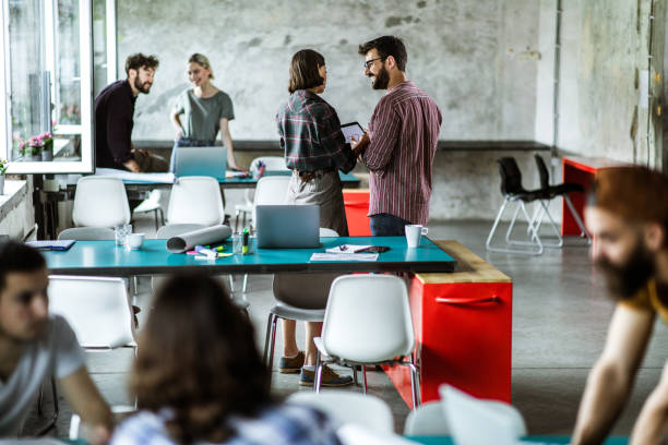 istock Group of design professionals working in a casual office. 1151776885