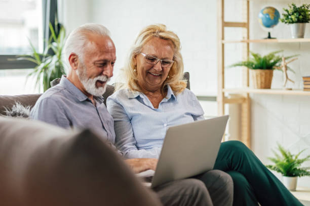 istock Happy senior couple surfing the net on a computer at home. 1151778795