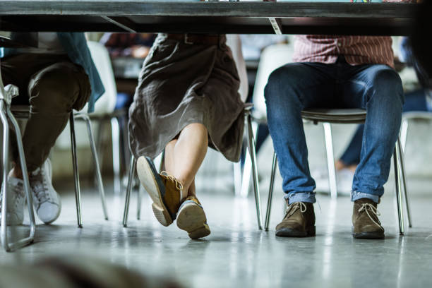 istock Unrecognizable people's legs under the table in the office. 1151779016