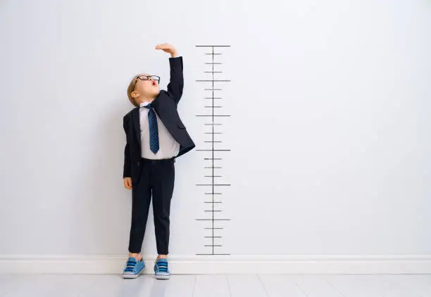 Photo of Kid is measuring the growth