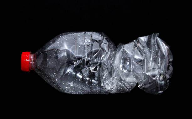 istock Empty plastic bottle isolated on black background. Nature protection concept. 1151780384