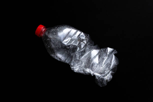 istock Empty plastic bottle isolated on black background. Nature protection concept. 1151780503