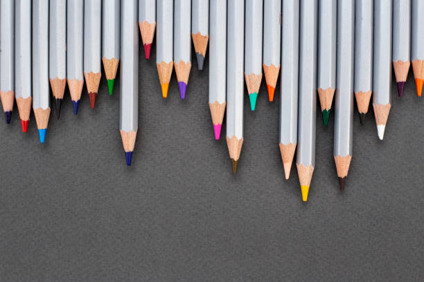 colored pencils on a black background. drawing supplies. space for text