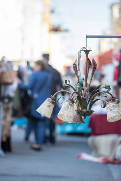 istock Flea market: Old fashioned lamp in the foreground, people in the blurry background 1151782789