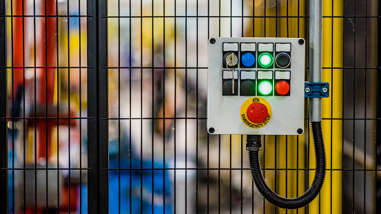 Control panel with push buttons on a factory metal mesh doors.