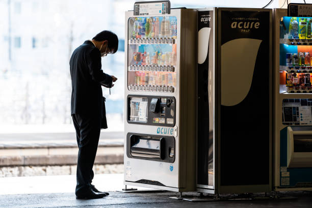 Train station platform for shinkansen or local line and man buying from vending machine Utsunomiya, Japan - April 4, 2019: Train station platform for shinkansen or local line and people businessman buying from vending machine cash in transit vehicle stock pictures, royalty-free photos & images