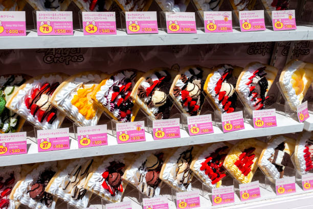 Takeshita street in Harajuku with display of many colorful dessert crepes French pancakes in store with prices Tokyo, Japan - April 2, 2019: Takeshita street in Harajuku with display of many colorful dessert crepes French pancakes in store with prices and signs japanese angel stock pictures, royalty-free photos & images
