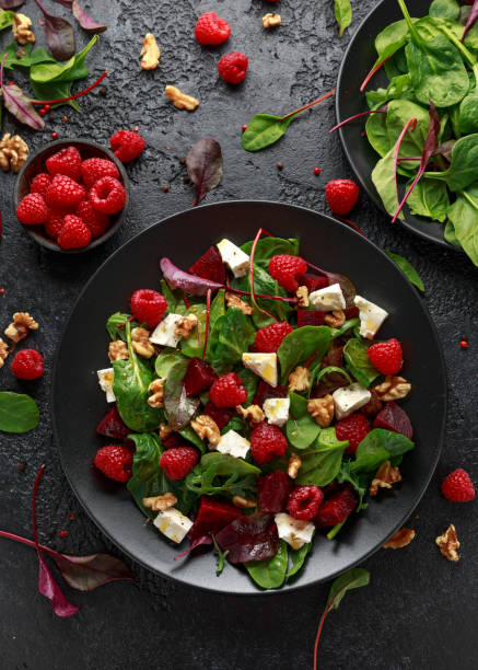 Healthy Beet Salad with raspberry, walnuts nuts and feta cheese Healthy Beet Salad with raspberry, walnuts nuts and feta cheese. salad fruit lettuce spring stock pictures, royalty-free photos & images