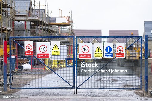 istock Construction building site entrance gate fence and health and safety signs 1151794658