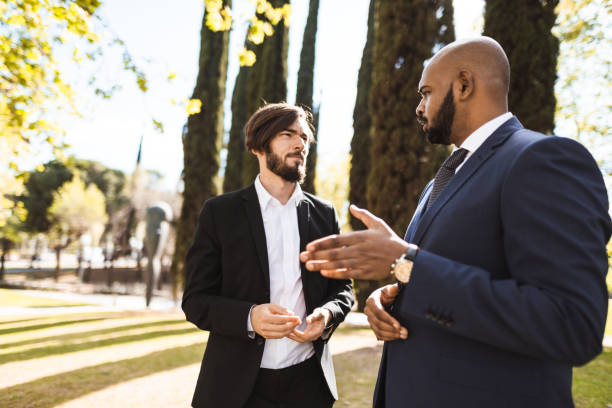 istock business man talking together in the park 1151794792