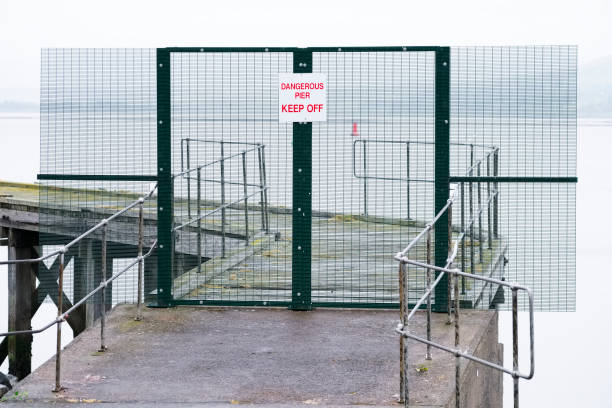 istock Dangerous pier keep off sign on abandoned sea jetty 1151794826