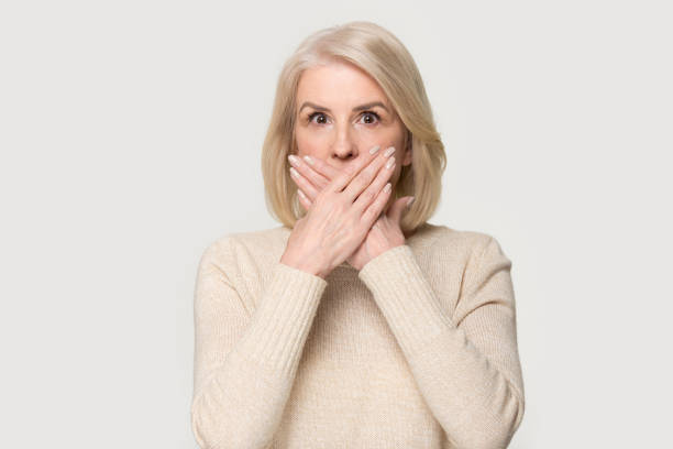 istock Shocked aged female covering mouth with hands feel scared 1151796042
