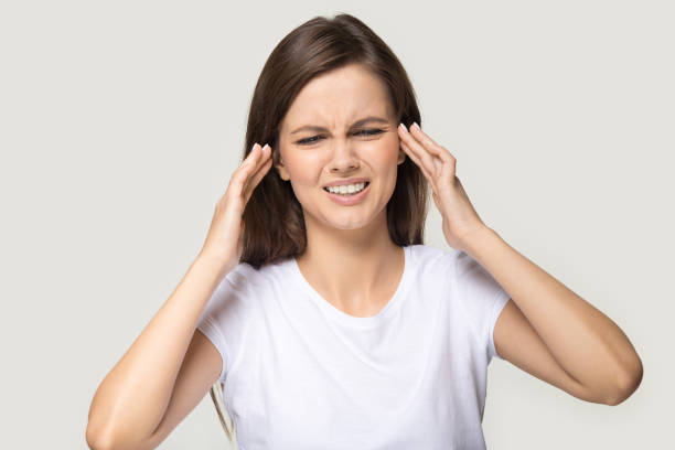 istock Millennial woman touching temples suffers from migraine studio shot 1151796099