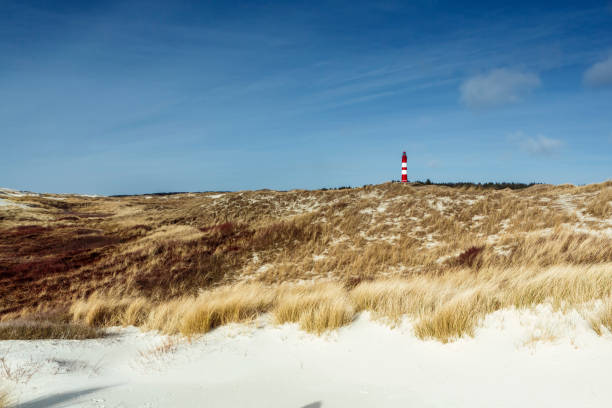 istock Red and white lighthouse on Amrum on the hill 1151797984