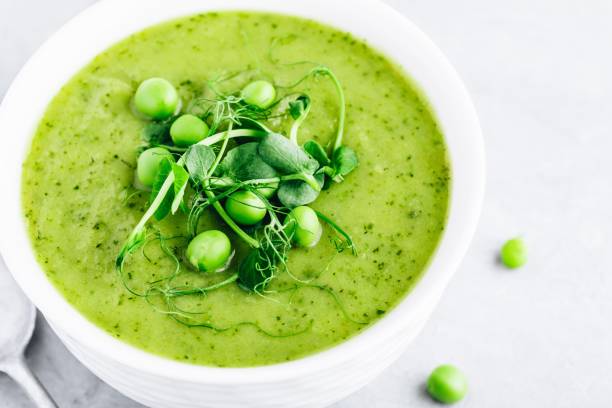 istock Summer cream soup with green fresh pea shoots 1151798494