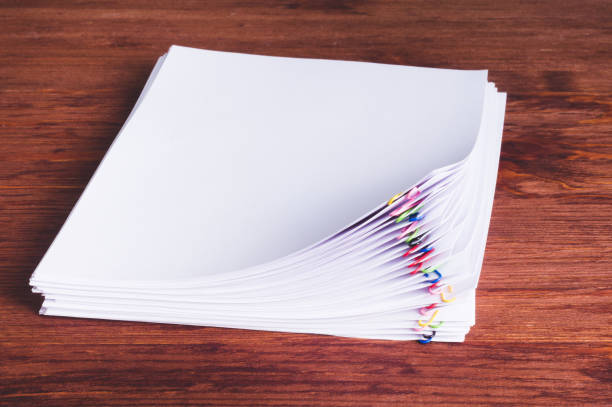 istock Stack of white papers with paper clips on office table 1151799937