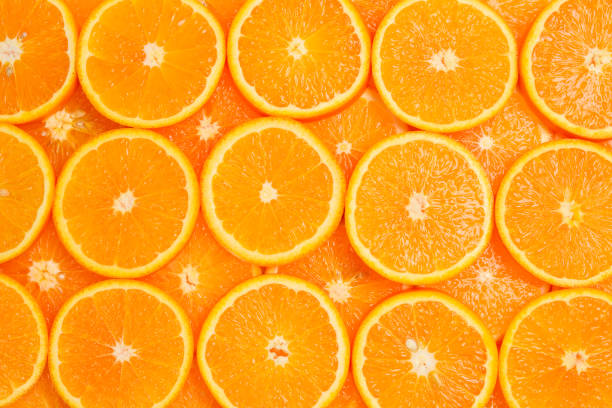 istock Slices of oranges as a background, top view. 1151801934