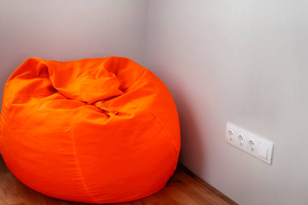 istock Big orange beanbag in the room corner. 1151802213