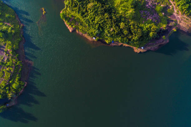 istock Dam with island green mountain forest blue water 1151802681
