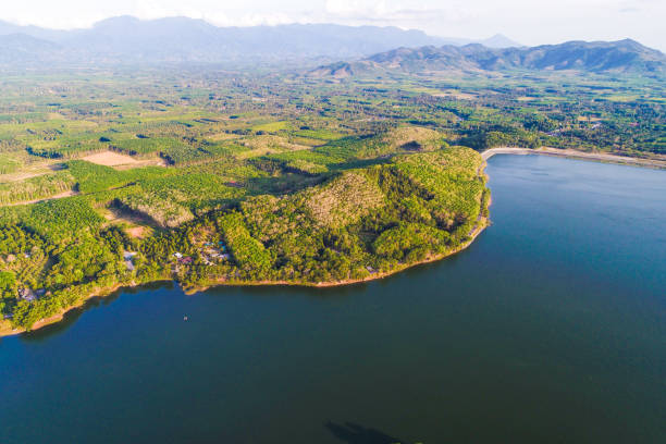 istock Dam with island green mountain forest blue water 1151802825