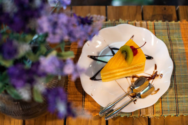 Orange cake in white dish on wooden table