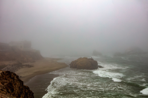 Fascinating View of Foggy Lands End with waves and cliffs at Pacific Ocean in San Francisco California USA