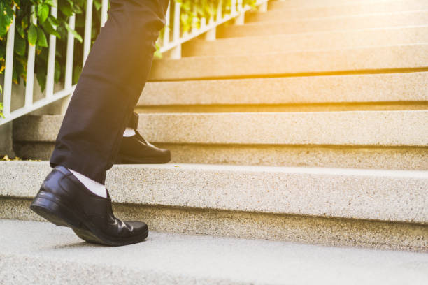 istock Businessman legs walking up the stairs 1151808217