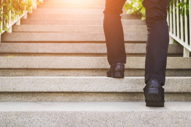 istock Businessman legs walking up the stairs 1151808281