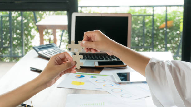 istock team building show hand try to put the missing jigsaw during hand 1151808391