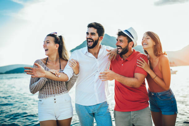 istock Cheerful friends enjoying weekend and having fun on beach 1151810957