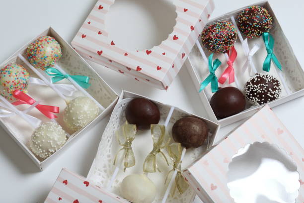 istock Cake pops decorated with a bow of braid, packed in a gift box. 1151811040