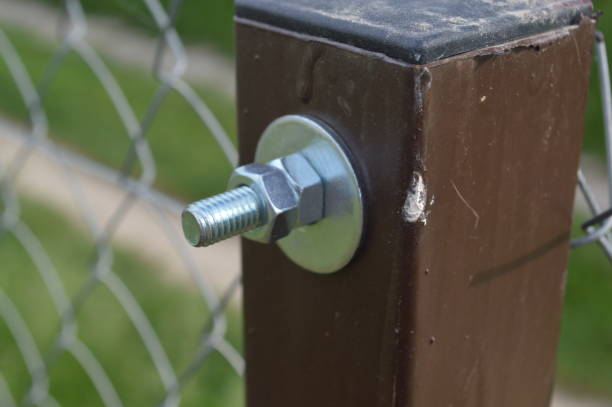 istock Construction of a fence from a chain-link grid 1151811434