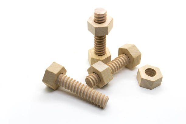istock Wooden nuts and bolts on white 1151811600