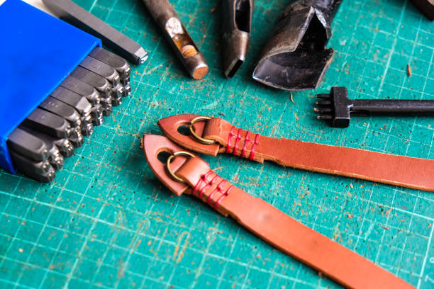 istock Genuine vegetble tanned leather of camera strap with tool on crafts 1151813108