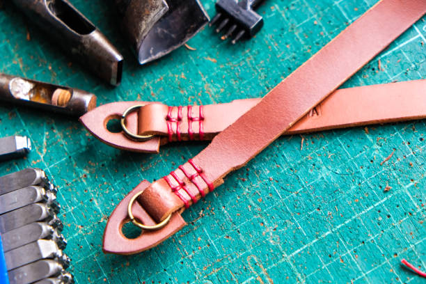 istock Genuine vegetble tanned leather of camera strap with tool on crafts 1151813162