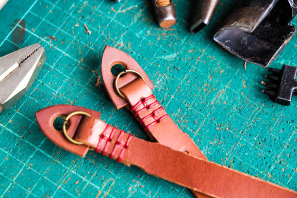 istock Genuine vegetble tanned leather of camera strap with tool on crafts 1151813814
