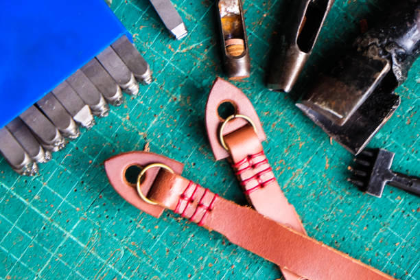 istock Genuine vegetble tanned leather of camera strap with tool on crafts 1151813925