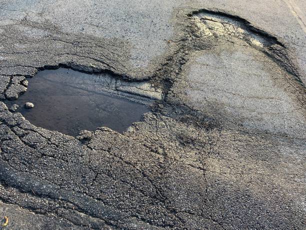 big hole cracked in the asphalt, road view