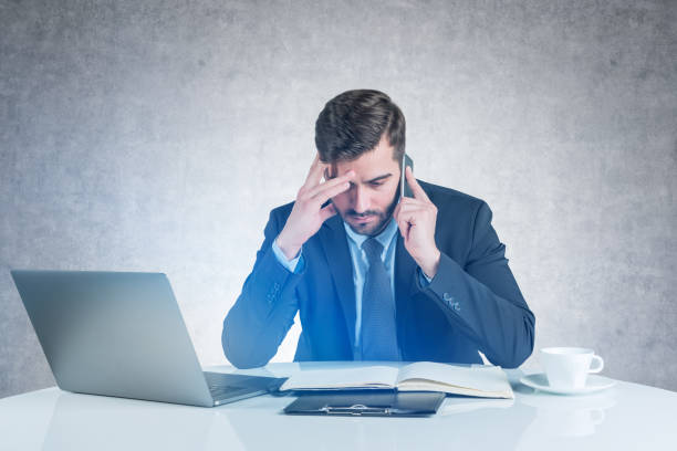 istock Pensive businessman on phone at table 1151816508