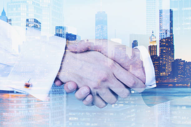 istock Double exposure with business handshaking on New York skyline. Blue toned image. 1151817323